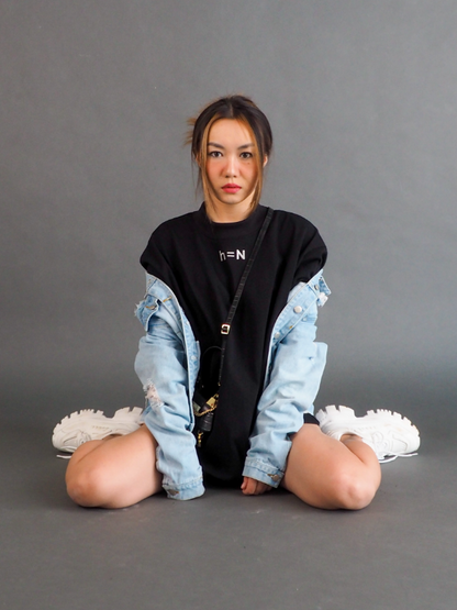 null hypothesis female model with denim jacket sitting on the floor