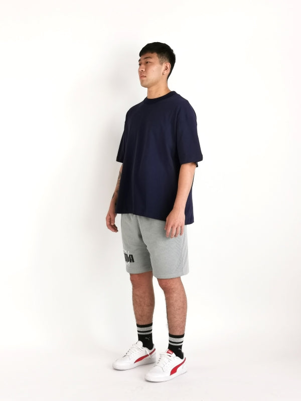 simple hypothesis essential oversized tee design on male model to display right diagonal side view